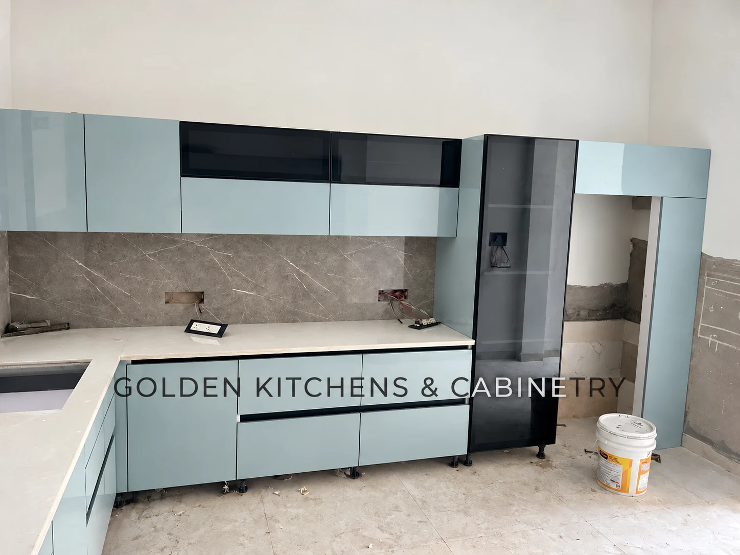 Pale blue kitchen tall storage during installation